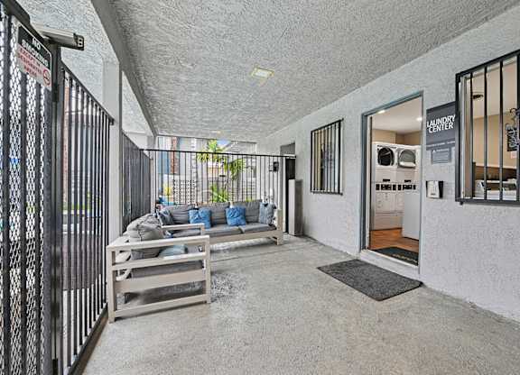 A room with a white wall and a black gate.