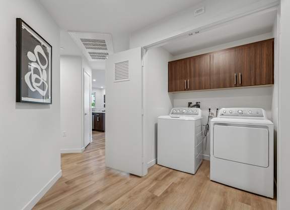 full-size in-unit washer and dryer at The Park apartment homes with overhead cabinetry