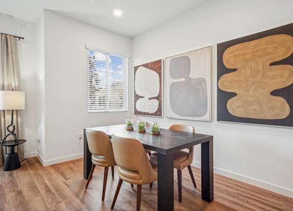 A dining room with a table and chairs at The Max on Jefferson Apartments, Murrieta, CA