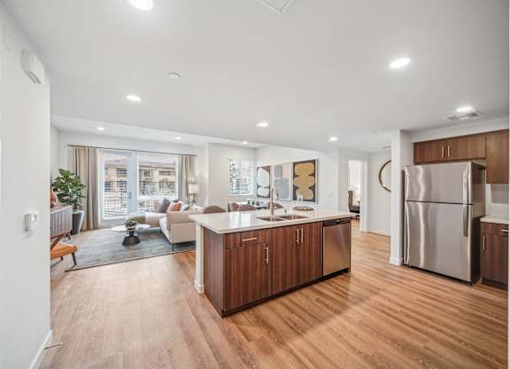 A modern kitchen with wooden floors and stainless steel appliances. at The Max on Jefferson Apartments, Murrieta, CA, 92562