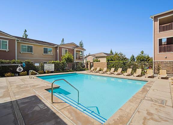Resort-style pool area at Turtle Creek surrounded by chaise lounges for optimal relaxation.