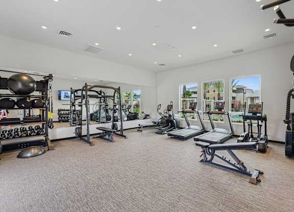 Spacious gym at The Park overlooking the pool area, with plenty of machines and great natural lighting.