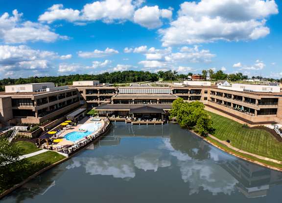 A large building complex with a pool in the middle.
