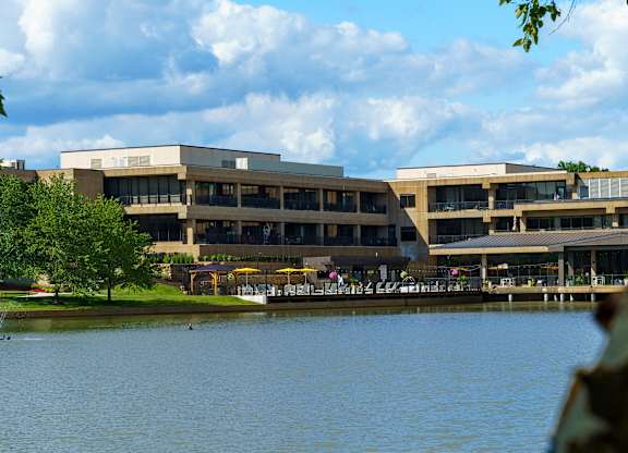 A large building with a lake in front of it.