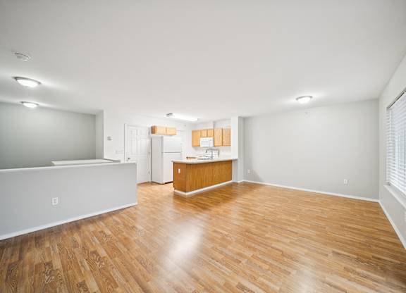 A room with wooden floors and white walls.