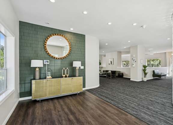 A room with a green wall and a gold and white cabinet.
