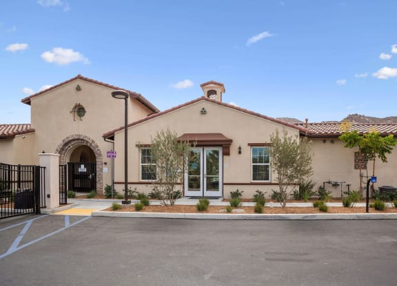 a building with a driveway and trees in front of it at Rancho Belago, Moreno Valley, CA, 92555