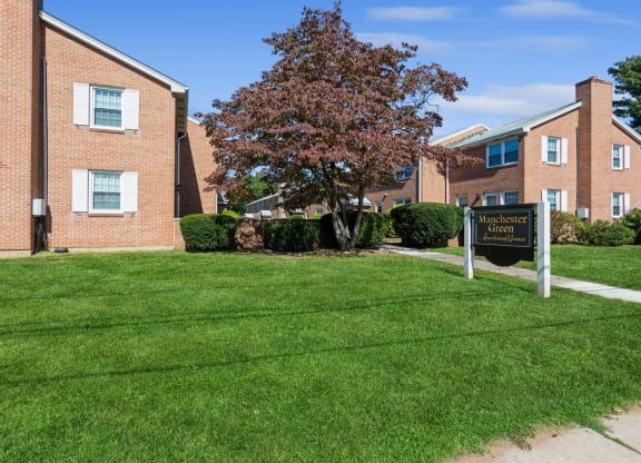 View of Manchester Green Apartments sign by the apartment complex