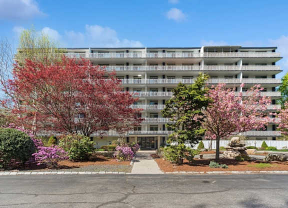 A large building with a parking lot in front of it.