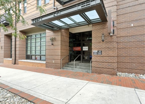 the entrance of a brick building with stairs