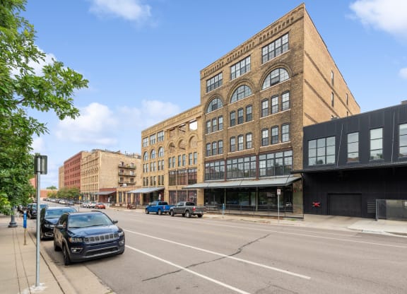 a large brick building on a city street at Gaar Scott Historic Lofts, Minnesota, 55401