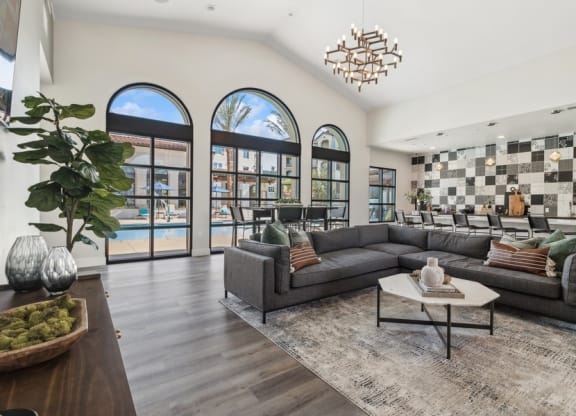 clubhouse that has large windows and a large couch and a coffee table at Arrive Temecula