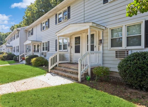 the front of a white house with a porch and a lawnat Fox Hill Commons, Connecticut
