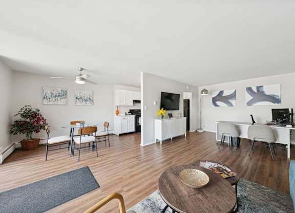 A living room with a wooden floor and white walls.