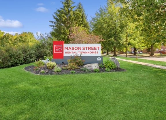 a sign in the middle of a grass field at Mason Street Townhomes, Grand Rapids, 49505