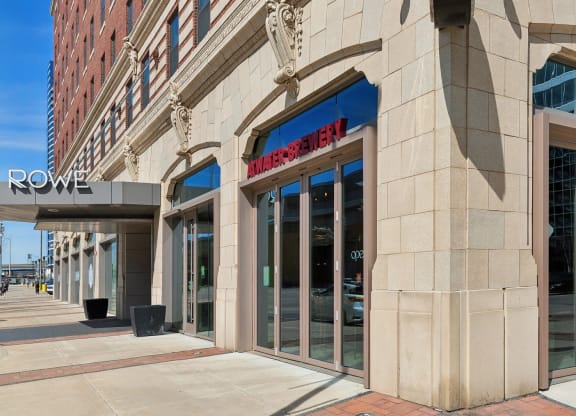 a building with a sign on the side of a street at The Rowe, Grand Rapids, MI