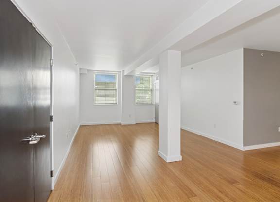A room with wooden floors and white walls.