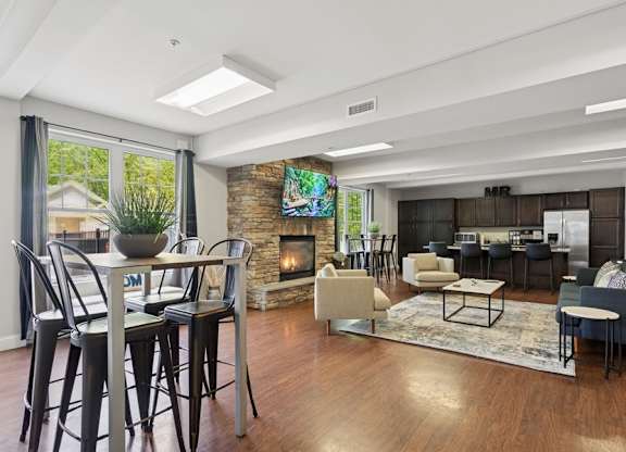 A modern living room with a fireplace and a dining table.