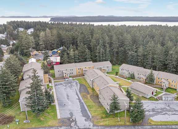 A large building complex surrounded by trees.