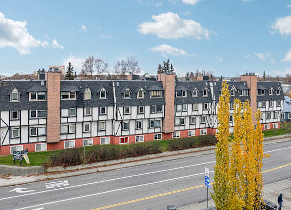 A street view of a building with a red and white facade.