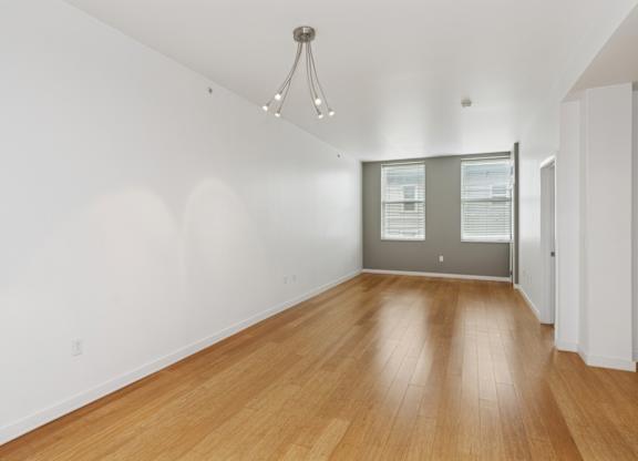 A room with wooden floors and a chandelier.
