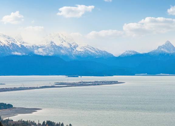 A large body of water with a mountain range in the background.