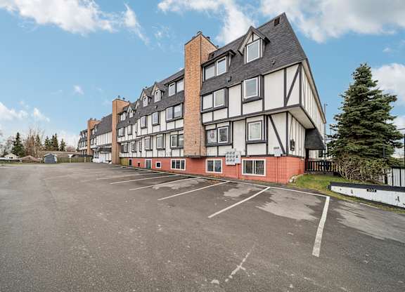 A large building with a parking lot in front of it.
