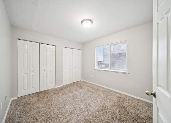 A room with white walls and a carpeted floor.