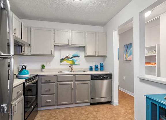 Kitchen with stainless steel appliances and white cabinets