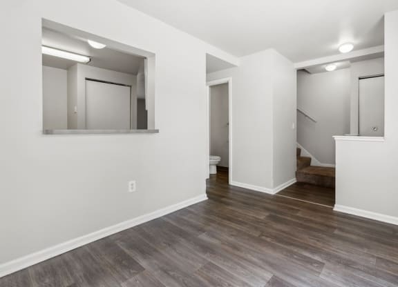 a living room with white walls and wood flooringat Mason Street Townhomes, Grand Rapids, 49505