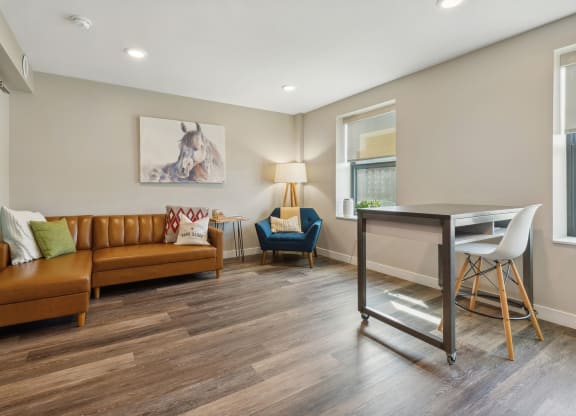 a living room with a couch and a desk at The Rowe, Grand Rapids, Michigan