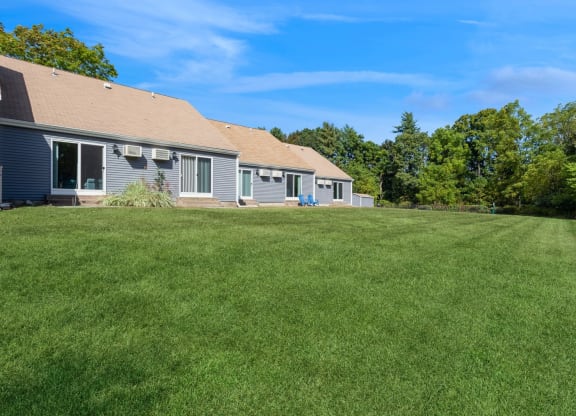 a large lawn in front of the apartments at Arbor Commons
