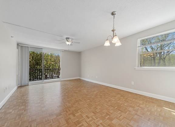 A room with a wooden floor and a ceiling fan.