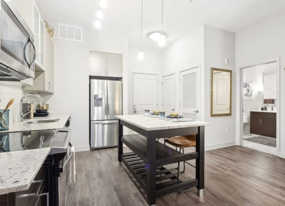 a kitchen with a large island and a refrigerator
