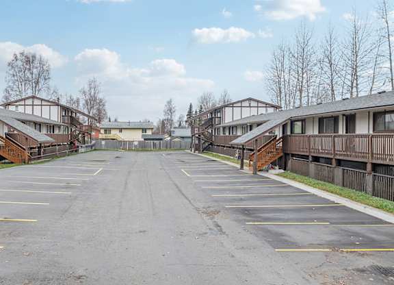 A parking lot with several cars parked in it.