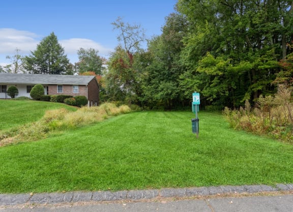 a house with a green yard and a mailbox in the grass