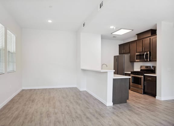 a kitchen and living room in a 555 waverly unit at Rancho Belago, Moreno Valley