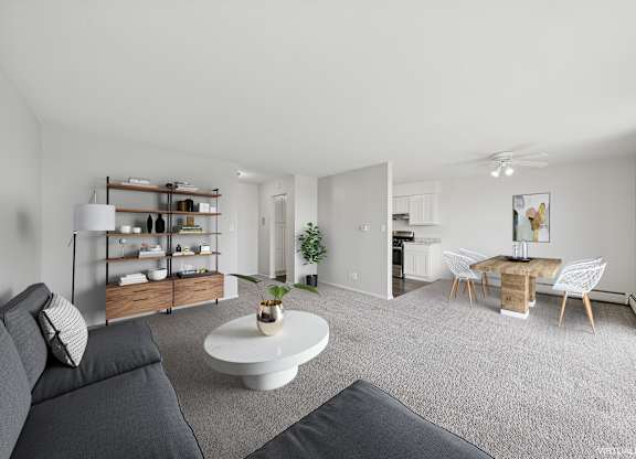 A living room with a grey sofa and a white coffee table.