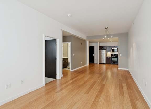 A room with wooden floors and white walls.