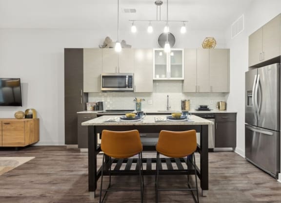 a kitchen and dining room with a table and chairs
