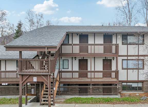 A two-story house with a balcony and a deck.