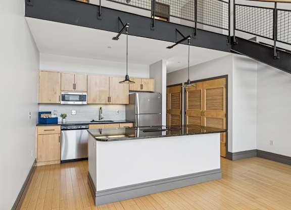 A modern kitchen with wooden cabinets and a white island.