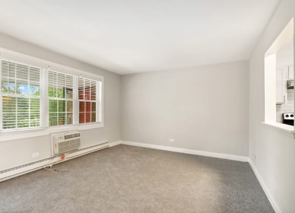 a bedroom with two windows and an air conditioner at The Hinsdale, Illinois