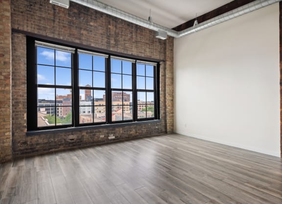 an empty room with a large windowat Gaar Scott Historic Lofts, Minnesota, 55401