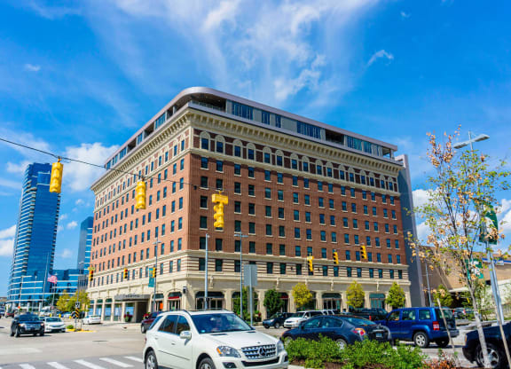 a large brick building with cars parked in front of it at The Rowe, Grand Rapids, Michigan