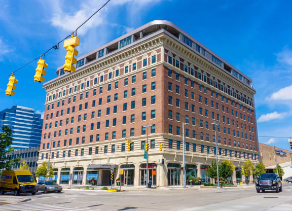 a large brick building with a traffic light in front of it at The Rowe, Grand Rapids, MI