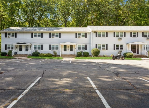 The white exterior with a parking lot in front of it at Fox Hill Commons, Connecticut, 06066