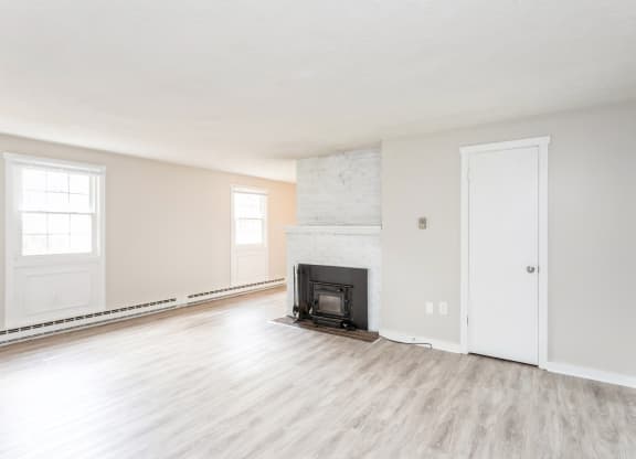 an empty living room with a fireplace at Stonebridge, Connecticut