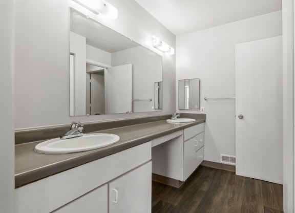 a bathroom with two sinks and a mirror at Mason Street Townhomes, Grand Rapids, 49505