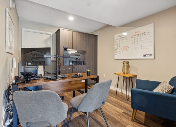 an office with a desk and chairs and a whiteboard at The Rowe, Michigan